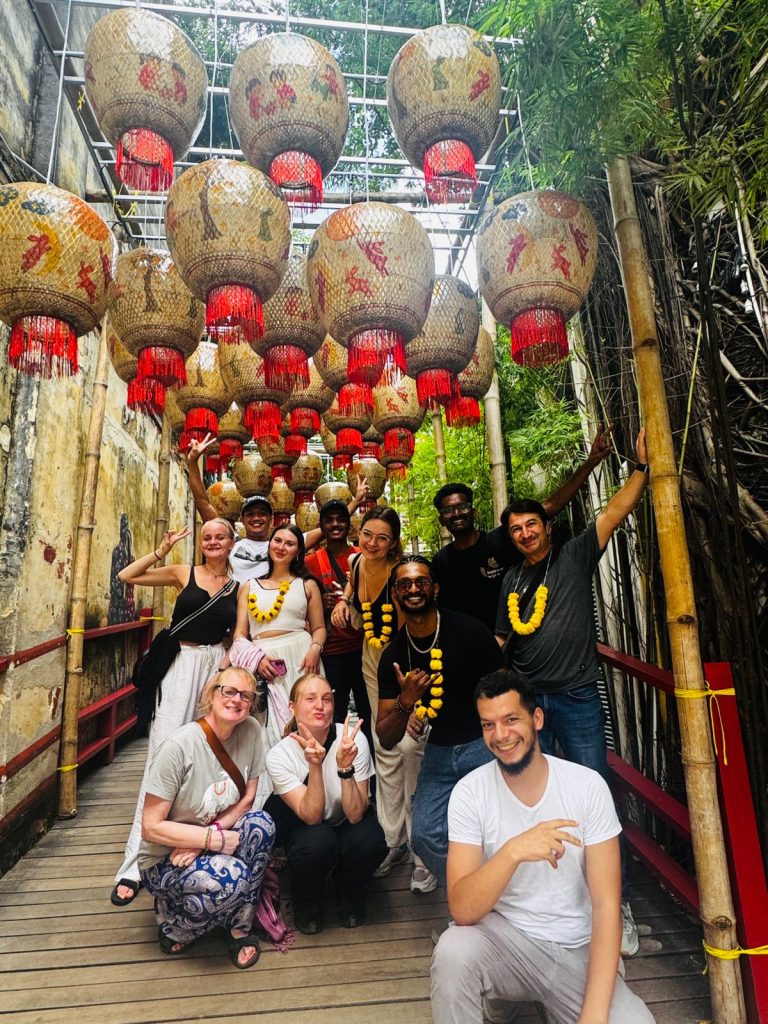 Travelogue Guesthouse guests under a lane strung with red lanterns in Chinatown