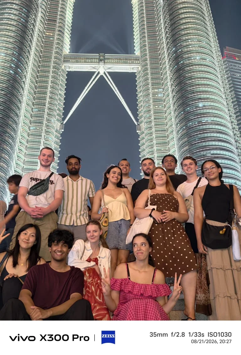 Travelogue Guesthouse group at the Petronas Twin Towers, Kuala Lumpur, at night