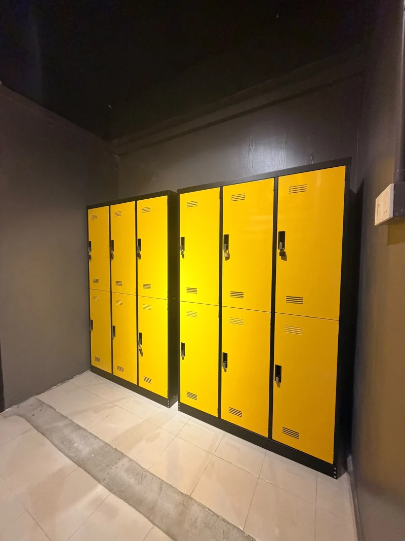 A bank of yellow lockers with padlocks on the doors at Travelogue Guesthouse, Bukit Bintang