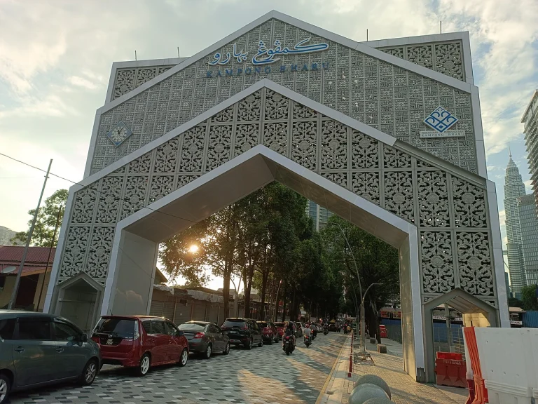 The gateway arch into Kampung Baru with the Petronas Twin Towers beyond it
