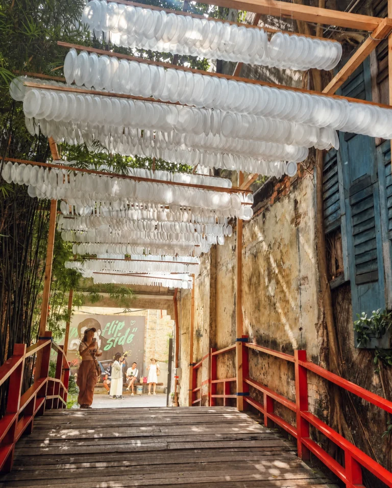 A canopy of white parasols over the red footbridge at Kwai Chai Hong, Kuala Lumpur Chinatown