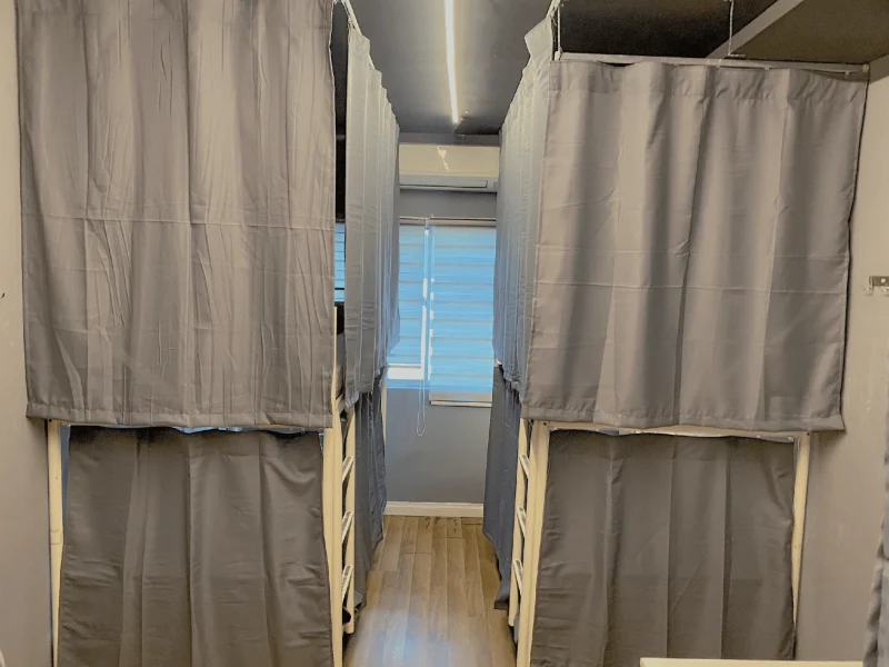The six bed mixed dormitory with privacy curtains at Travelogue Guesthouse, Bukit Bintang