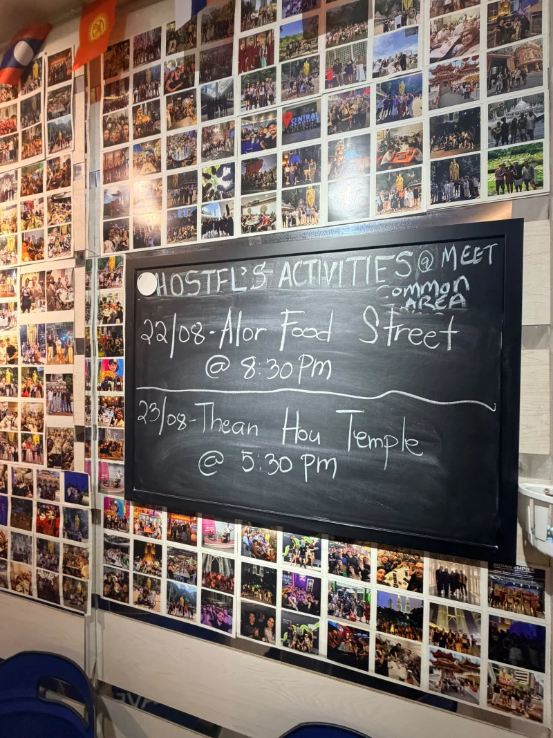The handwritten activity board at Travelogue Guesthouse reading Hostel's activities, meet common area, with this week's tours and times