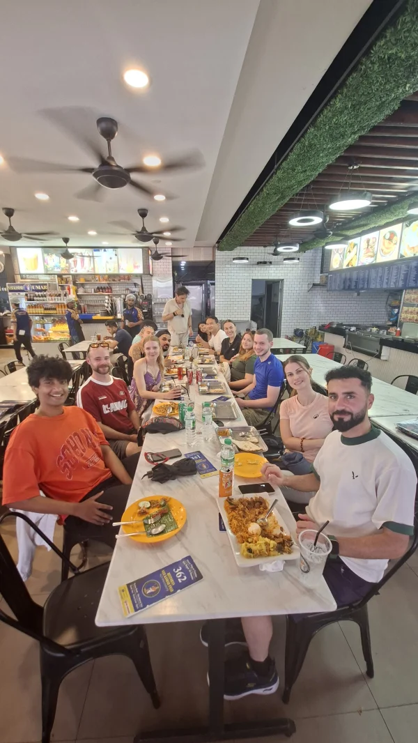 A Travelogue Guesthouse group round one table for lunch after the Batu Caves morning