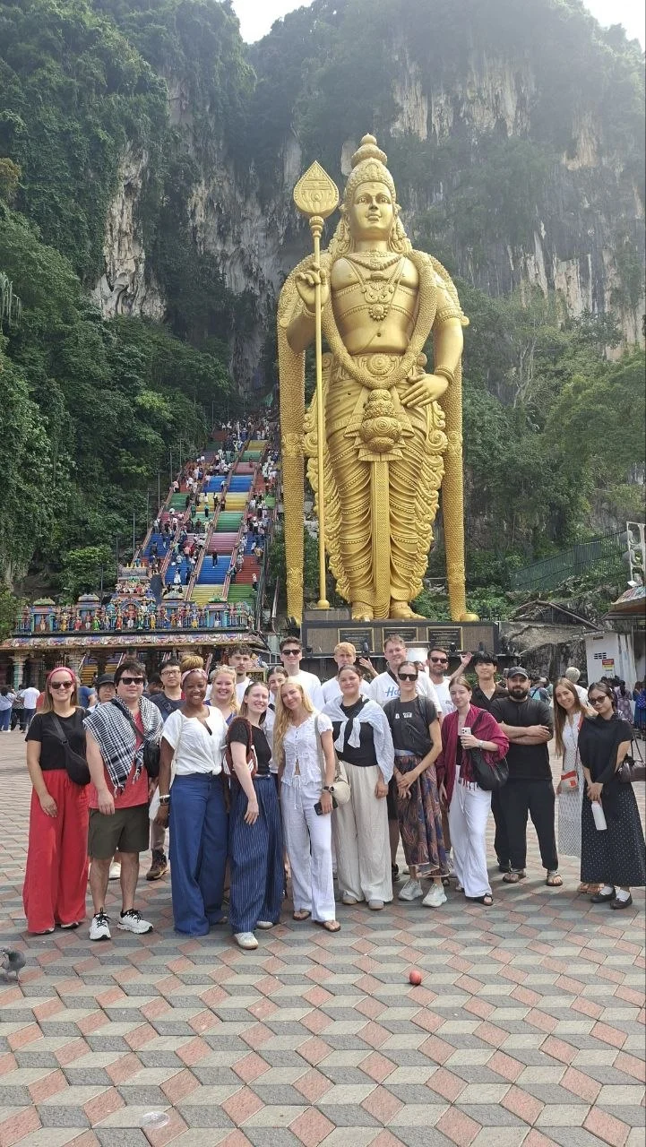 A Travelogue Guesthouse group below the Murugan statue at the bottom of the Batu Caves steps, Kuala Lumpur