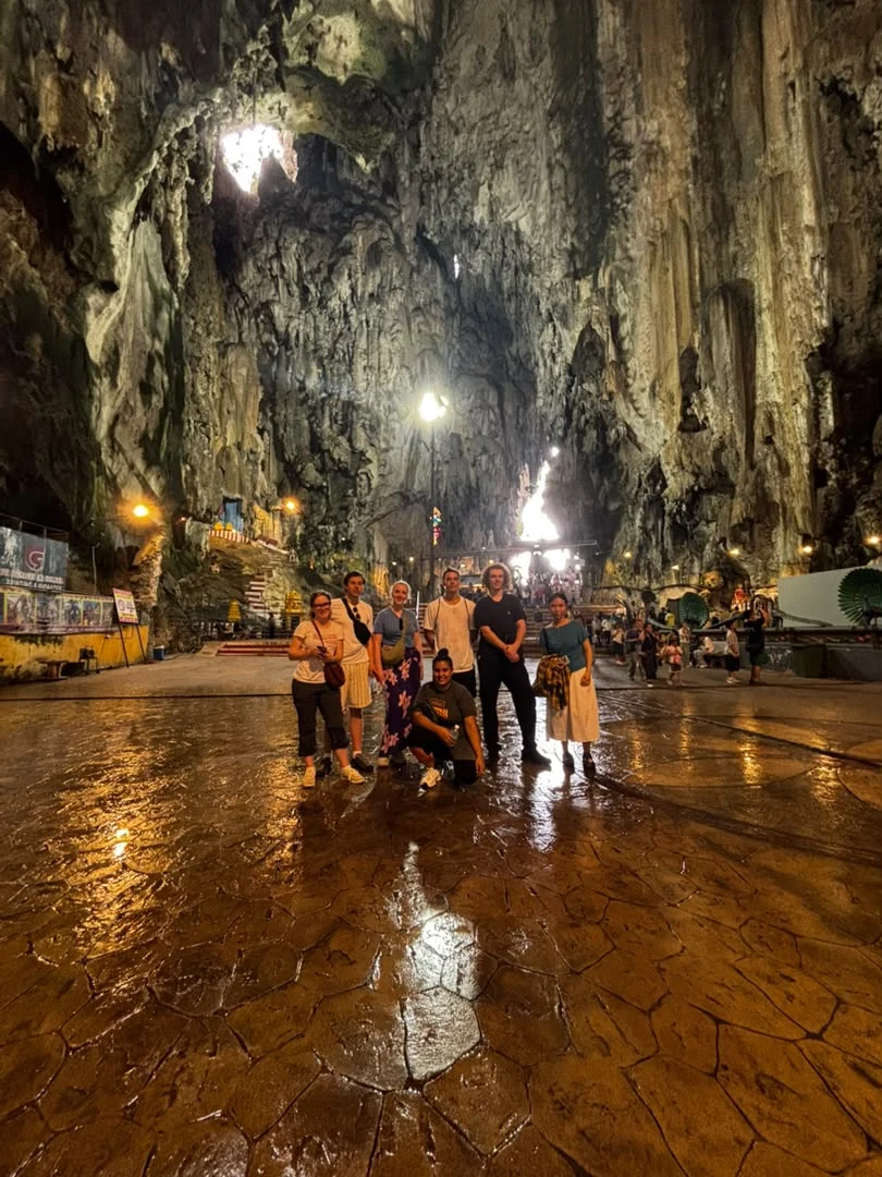 Travelogue Guesthouse guests standing inside the main cave at Batu Caves, Kuala Lumpur