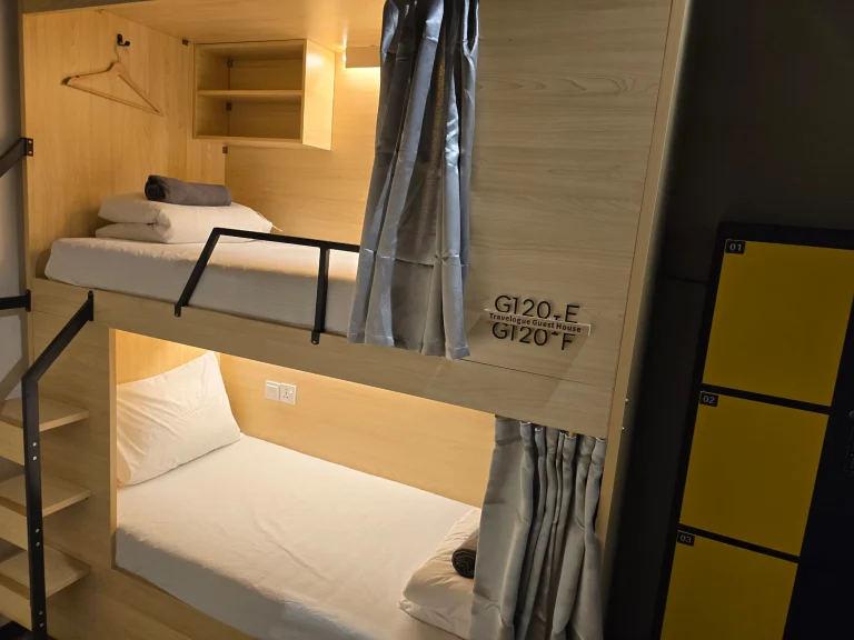 Bunks and yellow lockers in the female dormitory at Travelogue Guesthouse, Bukit Bintang