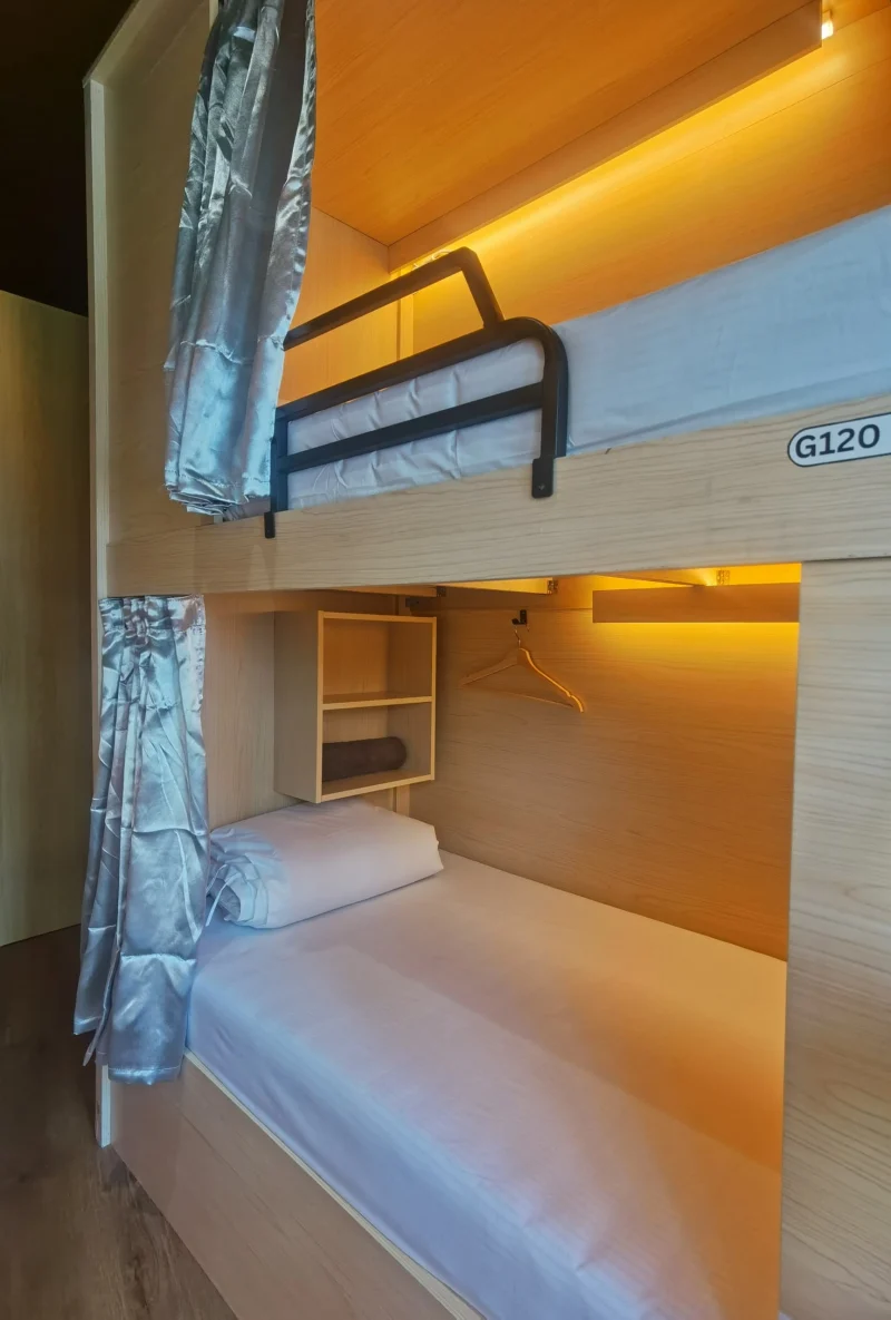 A pod bunk with its own reading light and shelf in the female dormitory at Travelogue Guesthouse