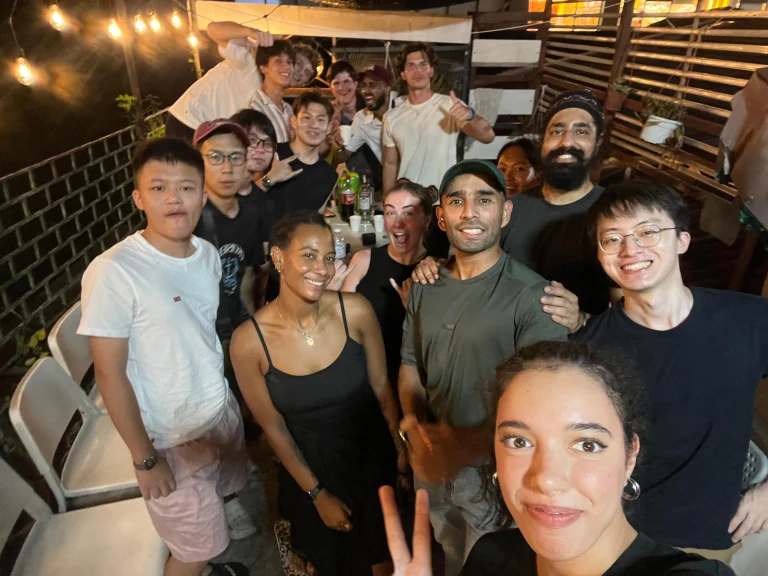 A Travelogue Guesthouse group together at a bar in Kuala Lumpur