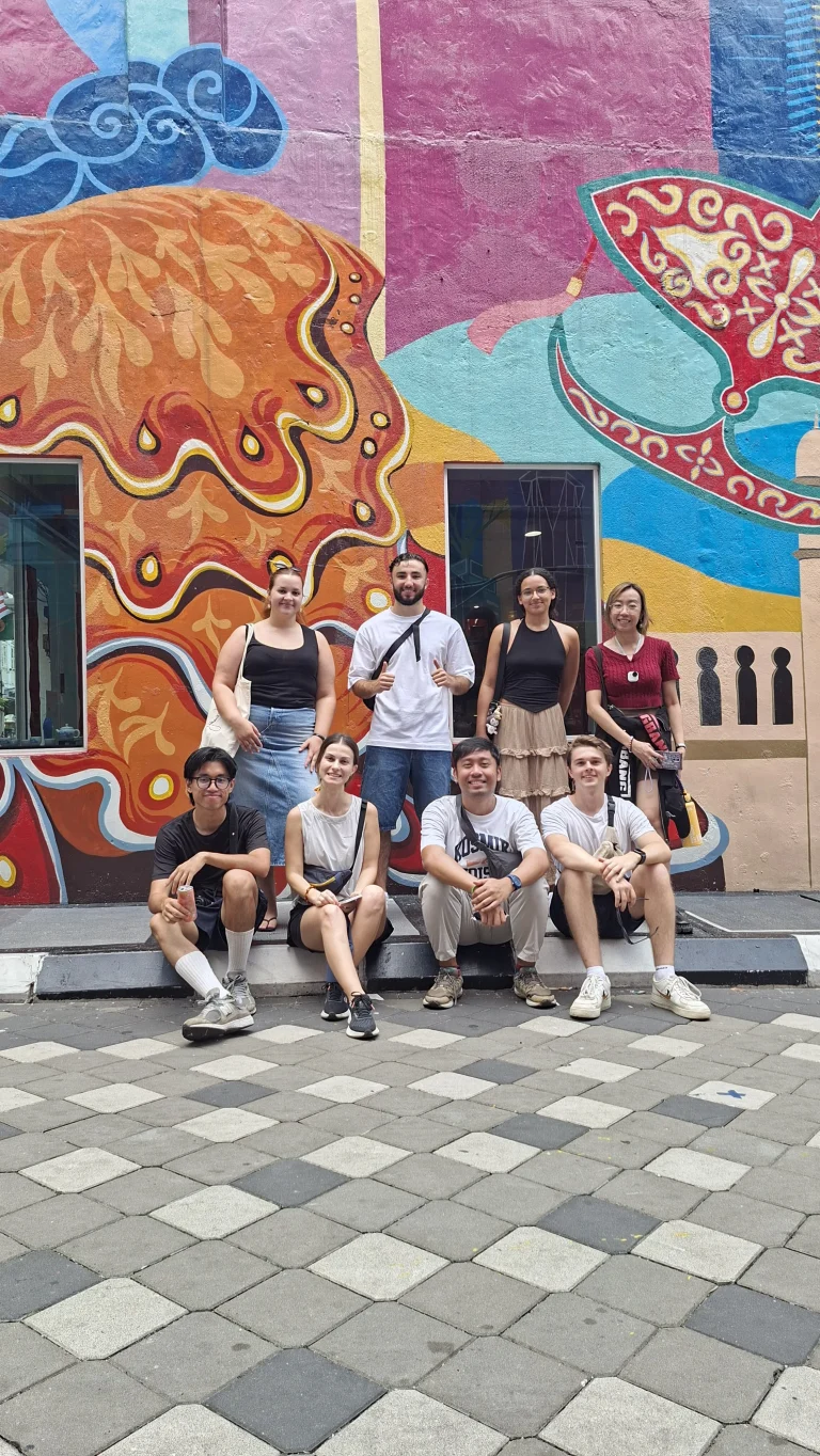 A Travelogue Guesthouse group in front of a painted wall at Graffiti Alley, Bukit Bintang