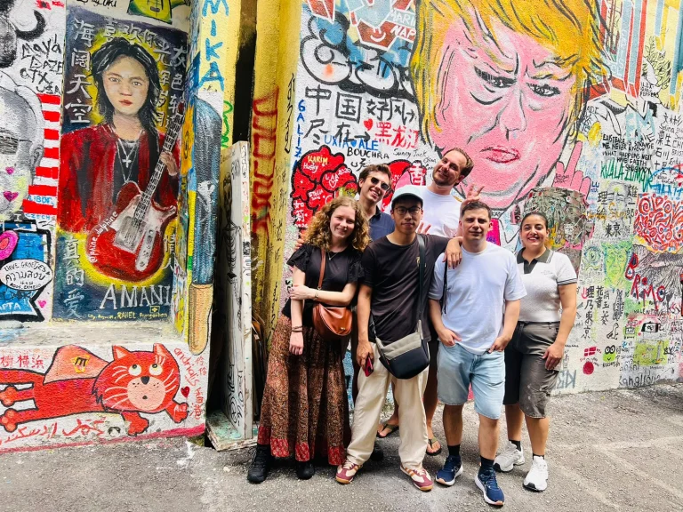 A Travelogue Guesthouse group in front of the painted wall at Graffiti Alley, Bukit Bintang
