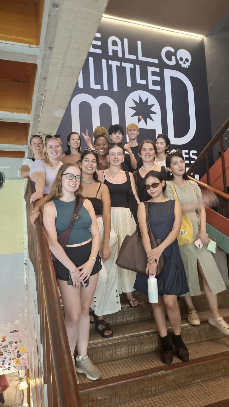 A Travelogue Guesthouse group on the painted staircase inside the hostel