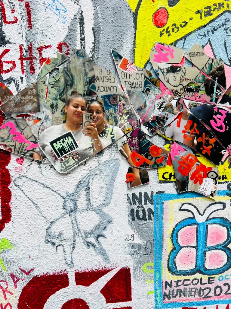 Travelogue Guesthouse guests at a wall of signatures in Graffiti Alley, Bukit Bintang