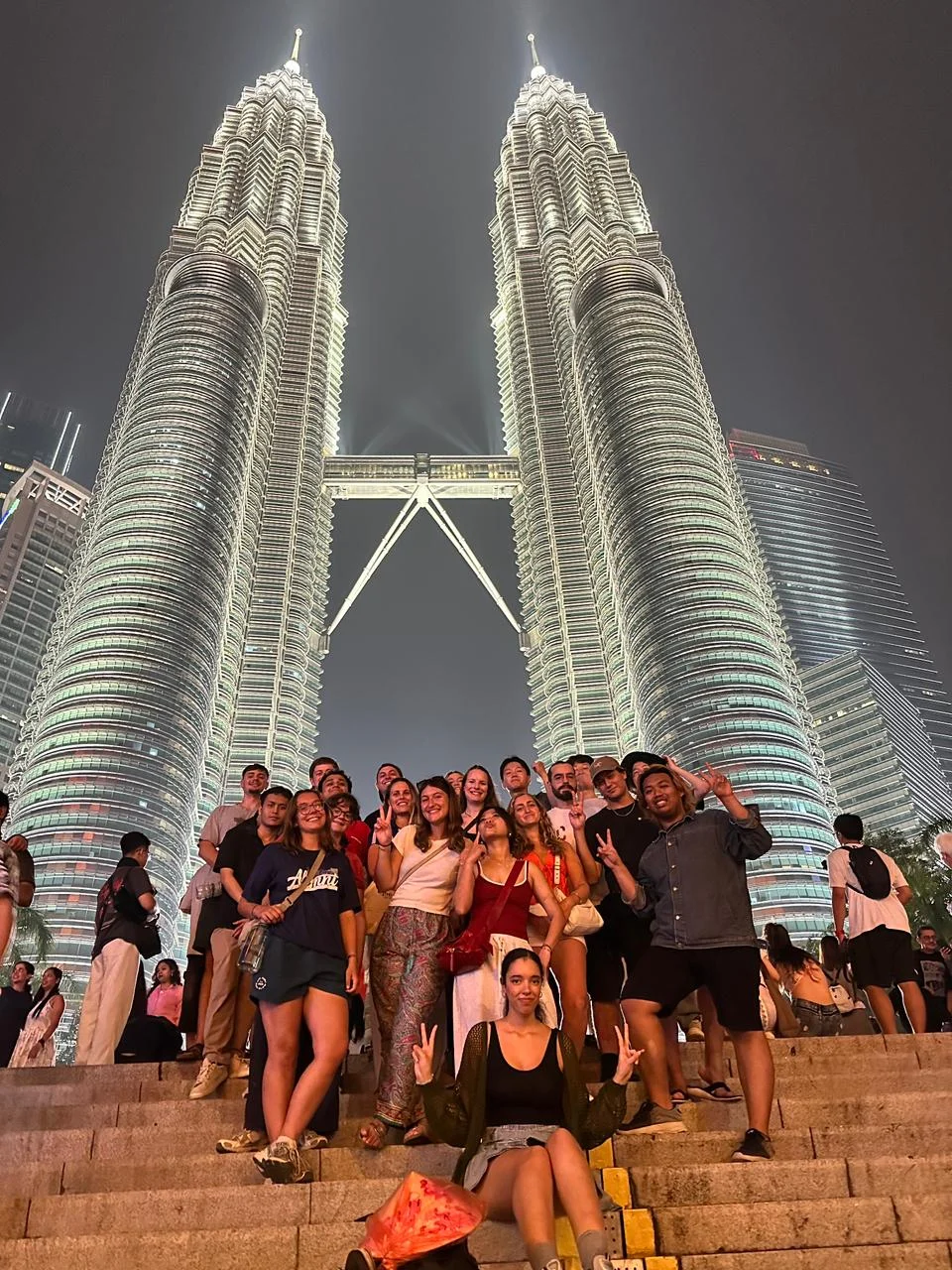 A Travelogue Guesthouse group on the steps below the Petronas Twin Towers