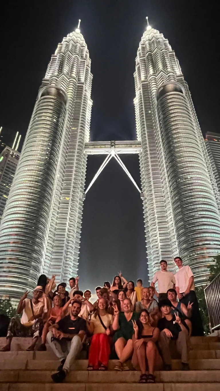 A Travelogue Guesthouse group filling the steps below the Petronas Twin Towers