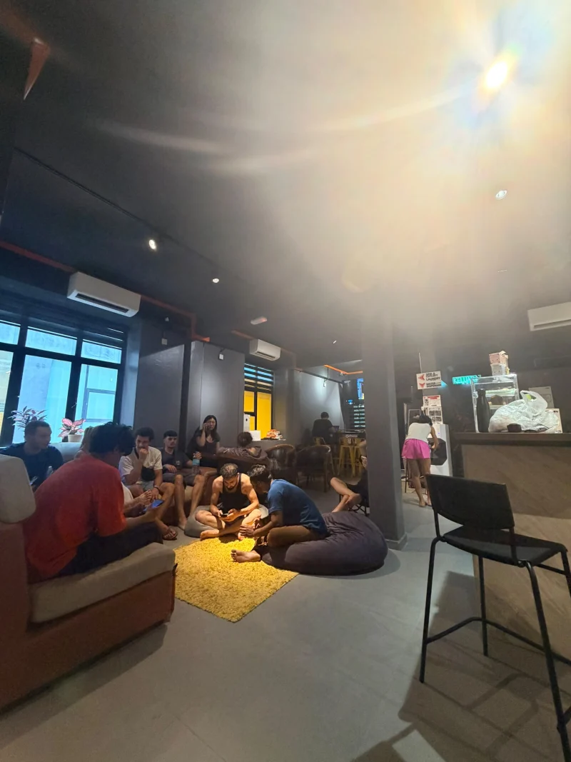 Guests sitting together on sofas and beanbags in the Travelogue Guesthouse common area, Bukit Bintang, Kuala Lumpur