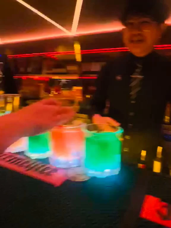 Drinks being set down along the bar counter on a Travelogue Guesthouse night out