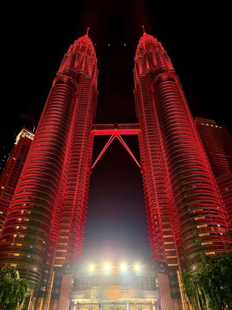 The Petronas Twin Towers lit red against a black sky, Kuala Lumpur