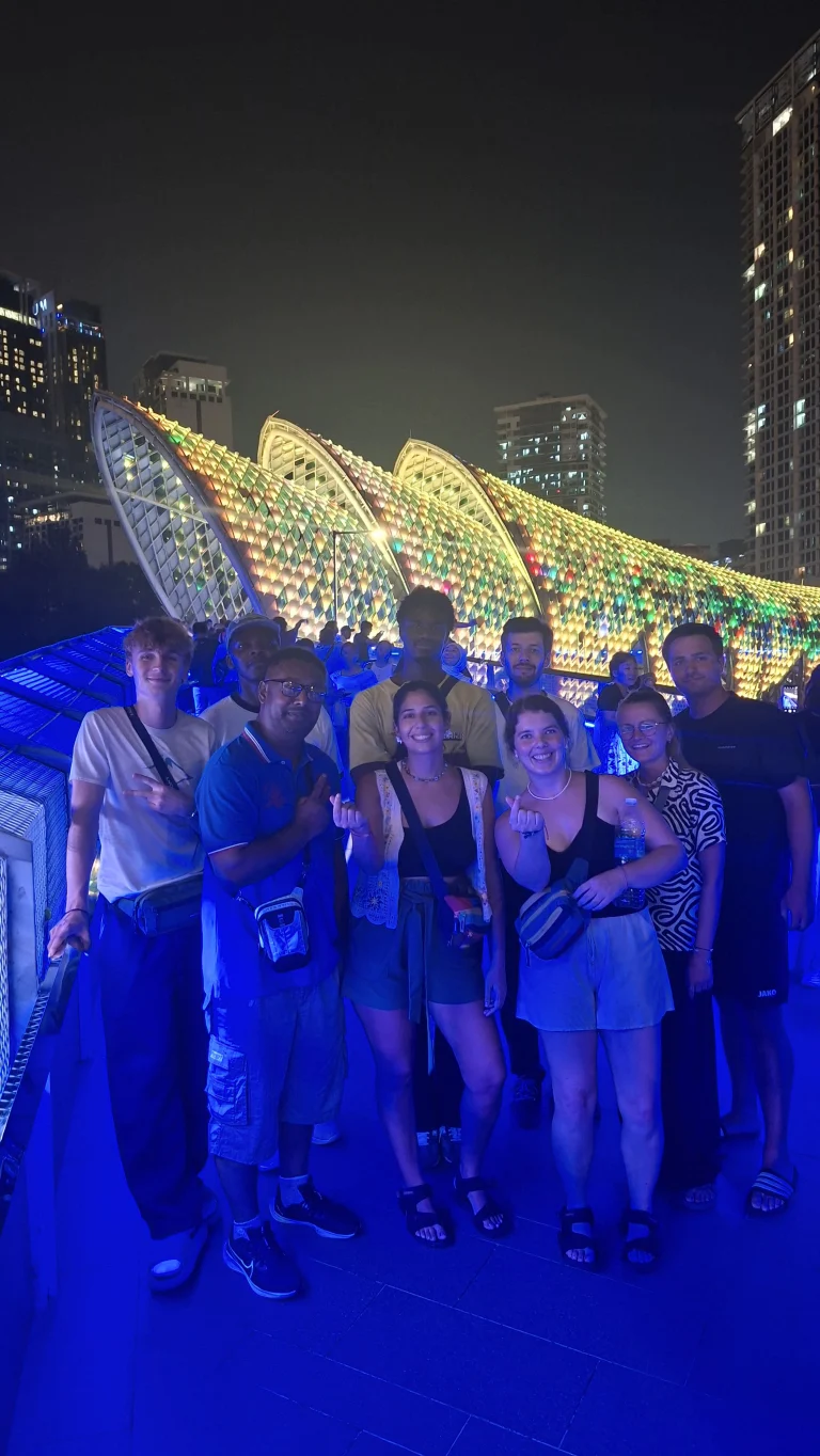 Travelogue Guesthouse guests under the lit canopy of the Saloma Link bridge