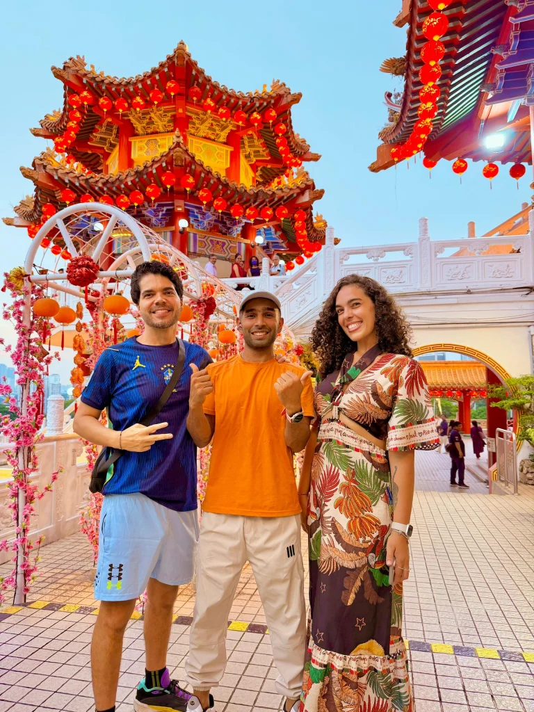 Travelogue Guesthouse guests beside the flower arch at Thean Hou Temple in daylight