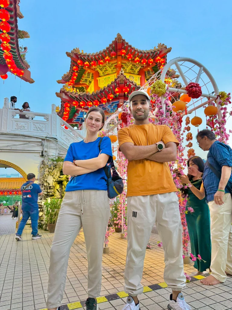 Travelogue Guesthouse guests beside the flower arch at Thean Hou Temple