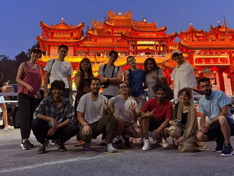 Travelogue Guesthouse guests in front of Thean Hou Temple lit at dusk, Kuala Lumpur