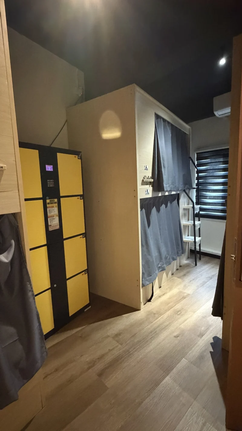 Yellow lockers beside a pod bunk and the window in the female dormitory at Travelogue Guesthouse, Bukit Bintang